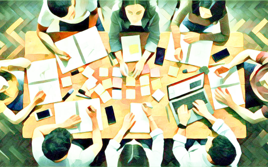 Teambesprechung um einen großen Tisch. Computer. Post-it.